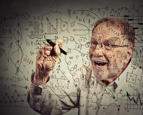 Senior man scientist with glasses writing secret formula with pen