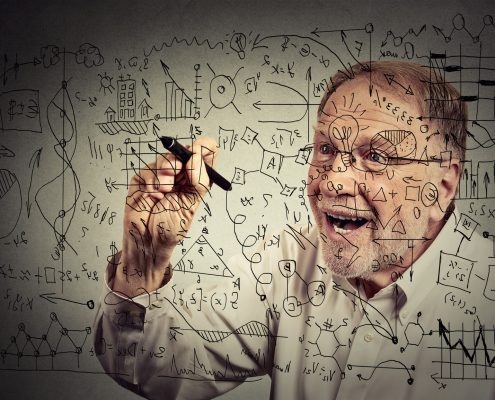 Senior man scientist with glasses writing secret formula with pen